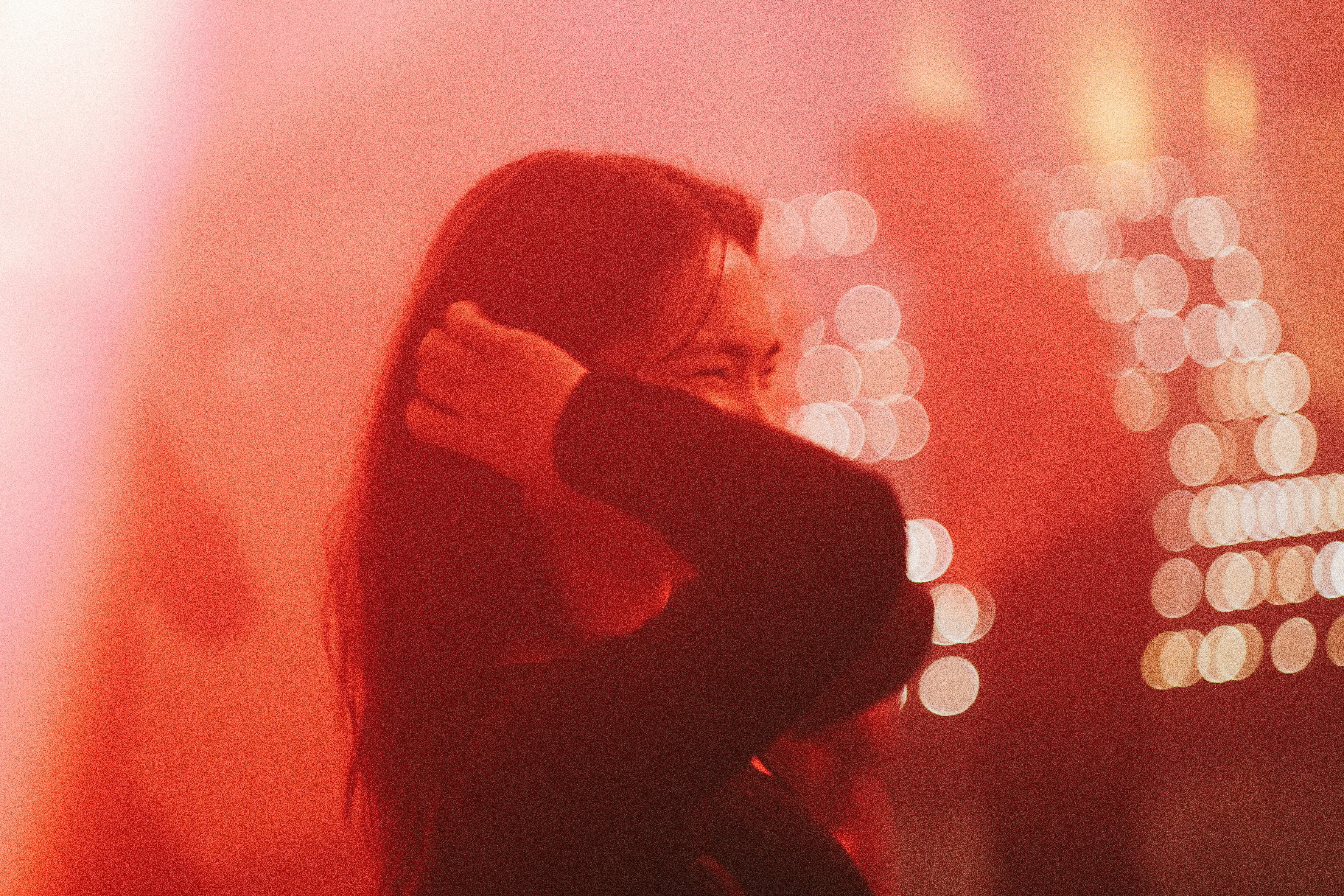 a woman standing in front of a red light