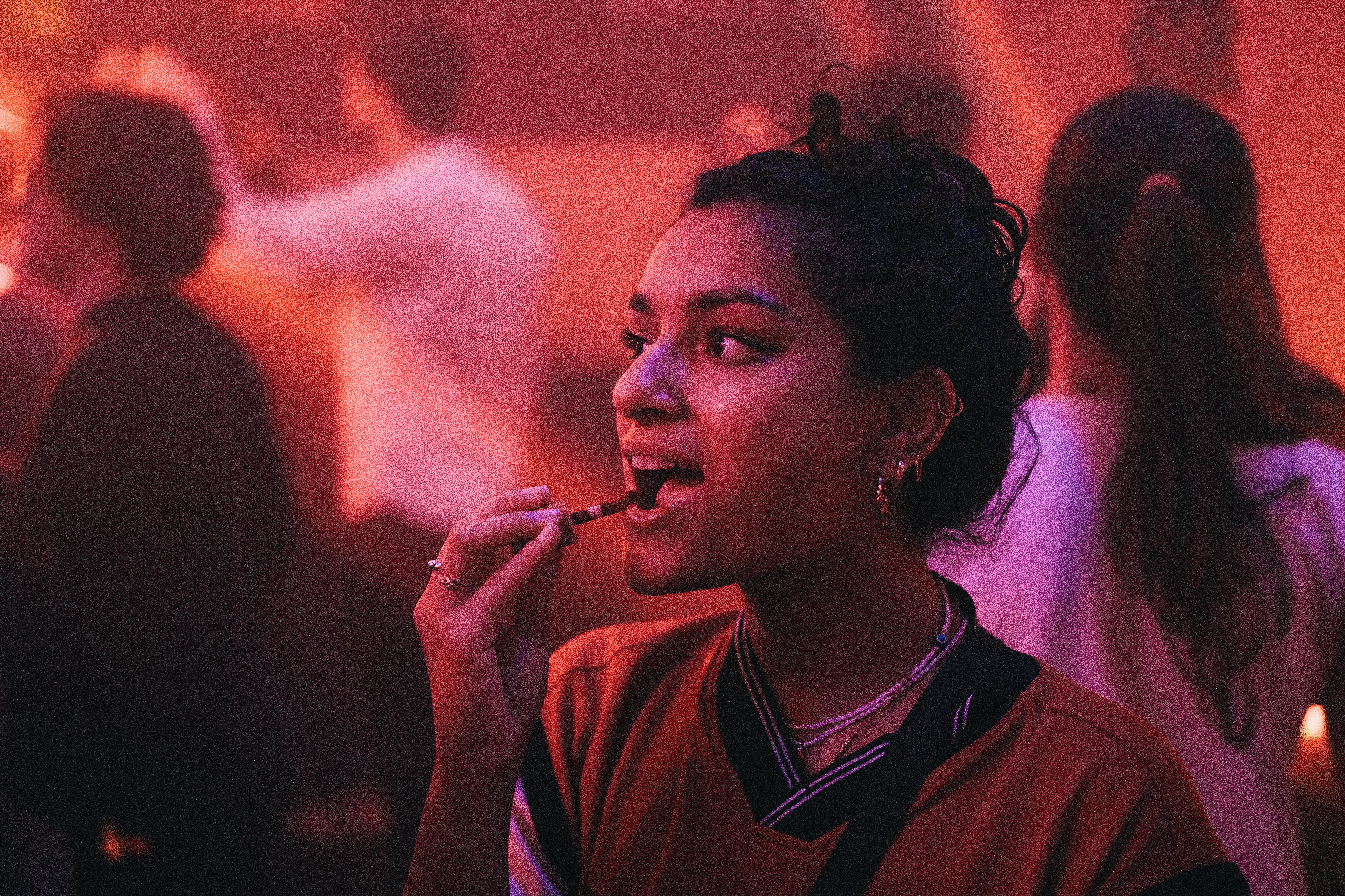 a woman smoking a cigarette in a crowded room