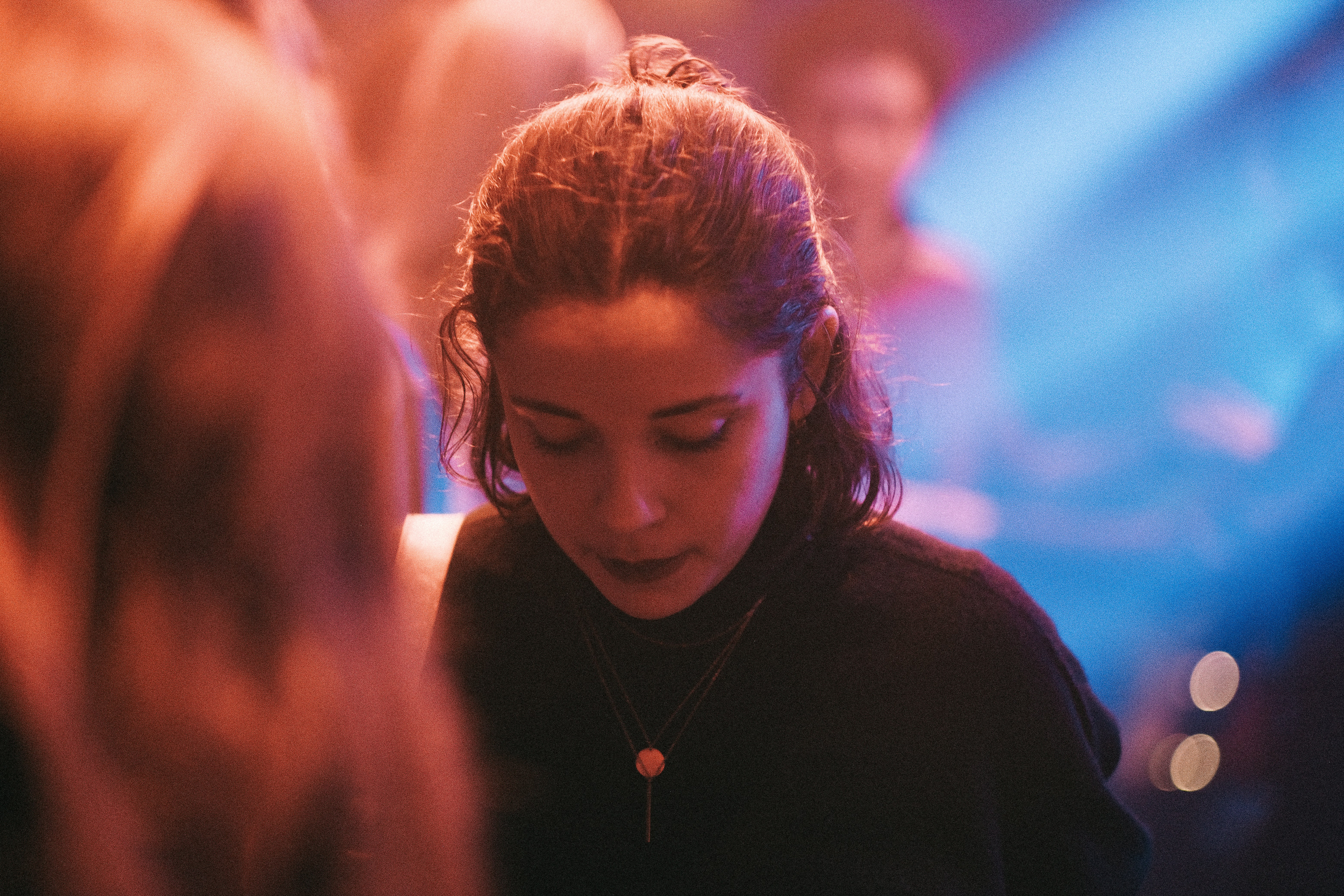 a woman looking down at her cell phone