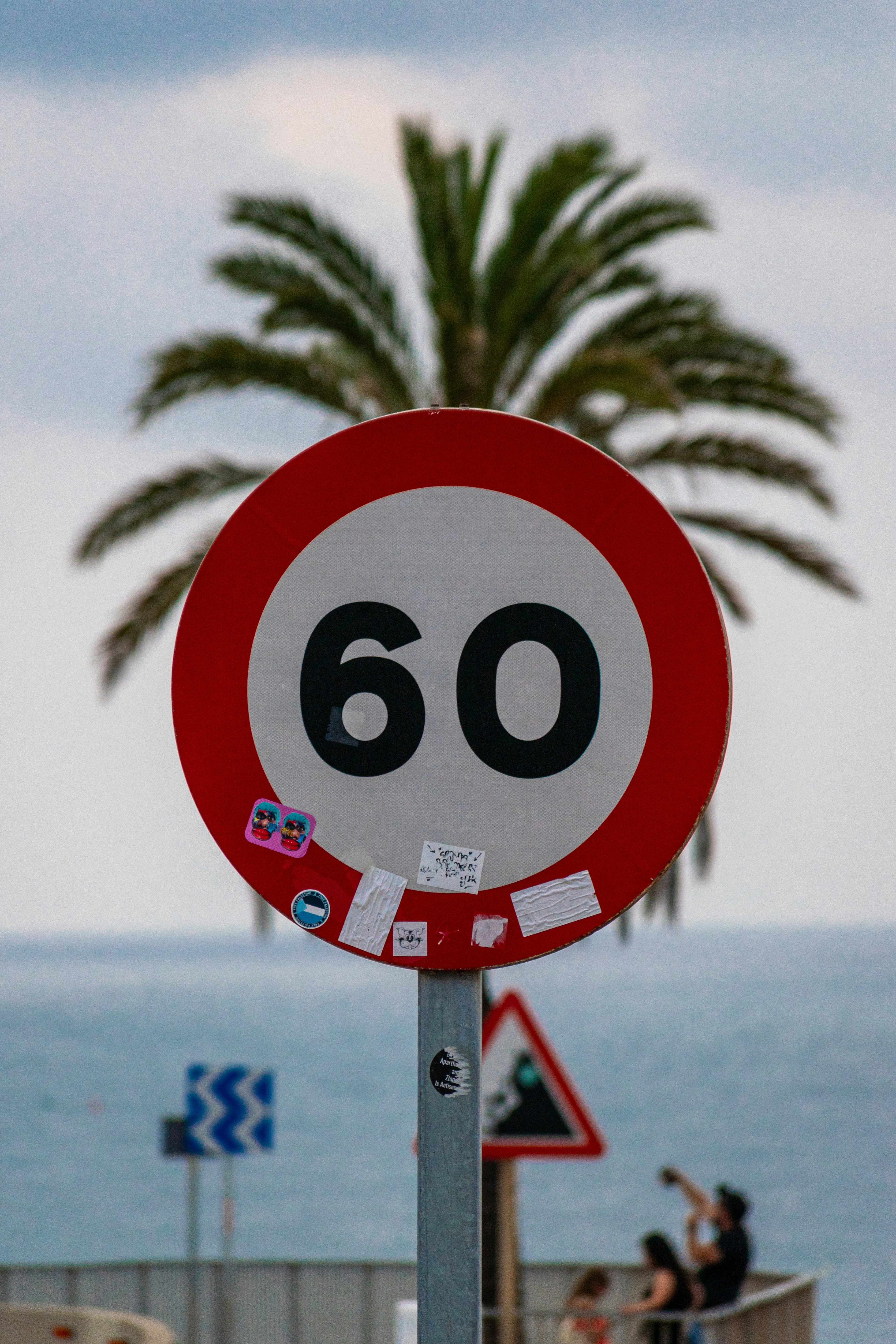 An international spec 60 kph sign, black numbers on white background with red border. circular.