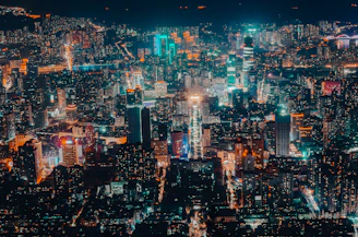 A vibrant cityscape at night with bustling streets and glowing lights.