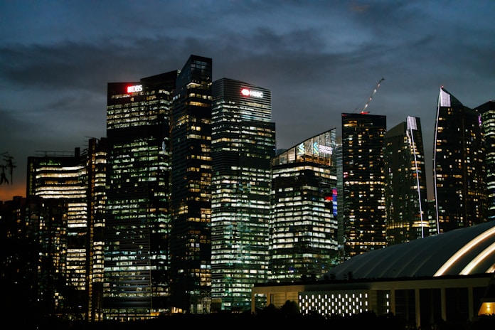 A sleek, modern office skyline at dusk symbolizing international business connections.