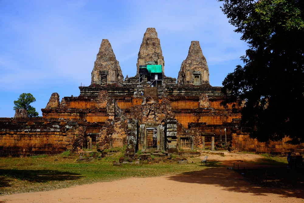 a large stone building with a green flag on top of it