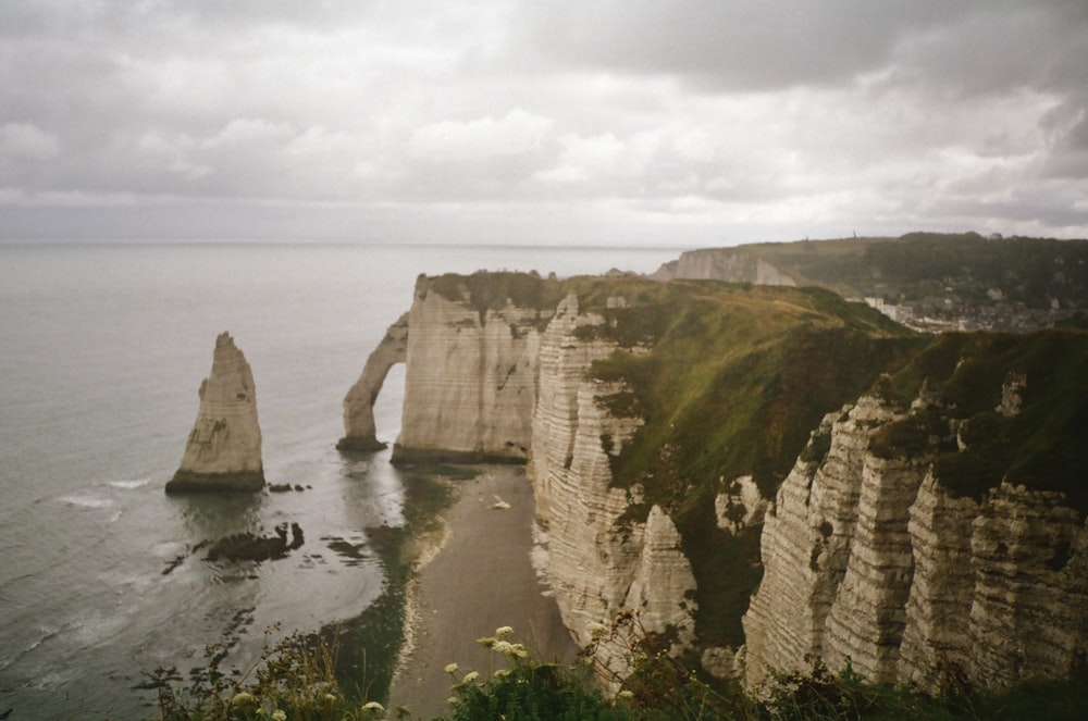 a large body of water next to a rocky cliff