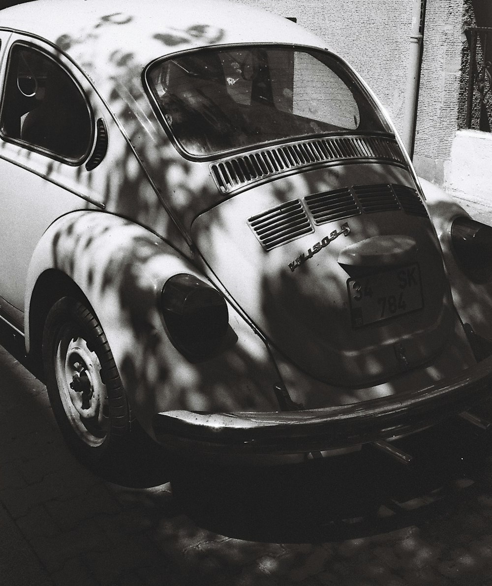 a black and white photo of a vw bug