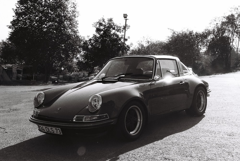 a black and white photo of a car parked in a parking lot