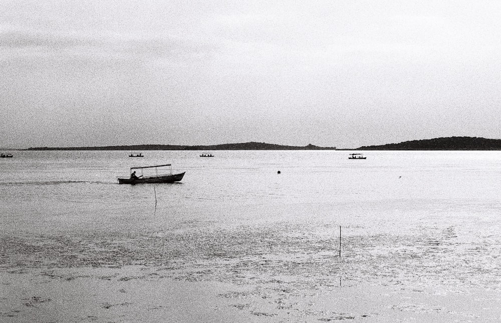 a black and white photo of boats in the water
