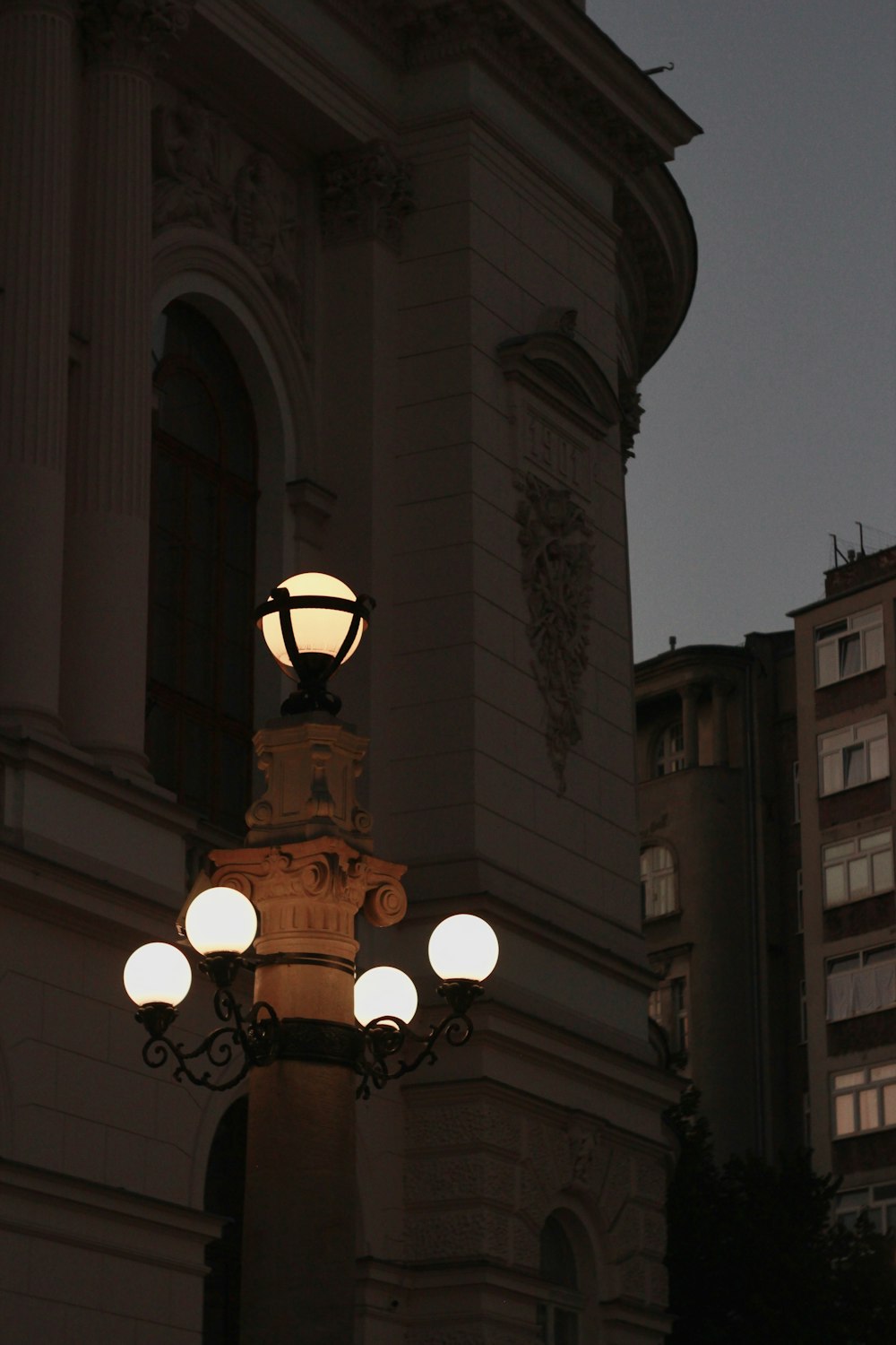 a street light with a building in the background