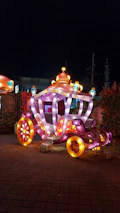 Magical crystal carriage surrounded by floating luminous butterflies and shimmering dust.