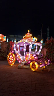 Magical crystal carriage surrounded by floating luminous butterflies and shimmering dust.