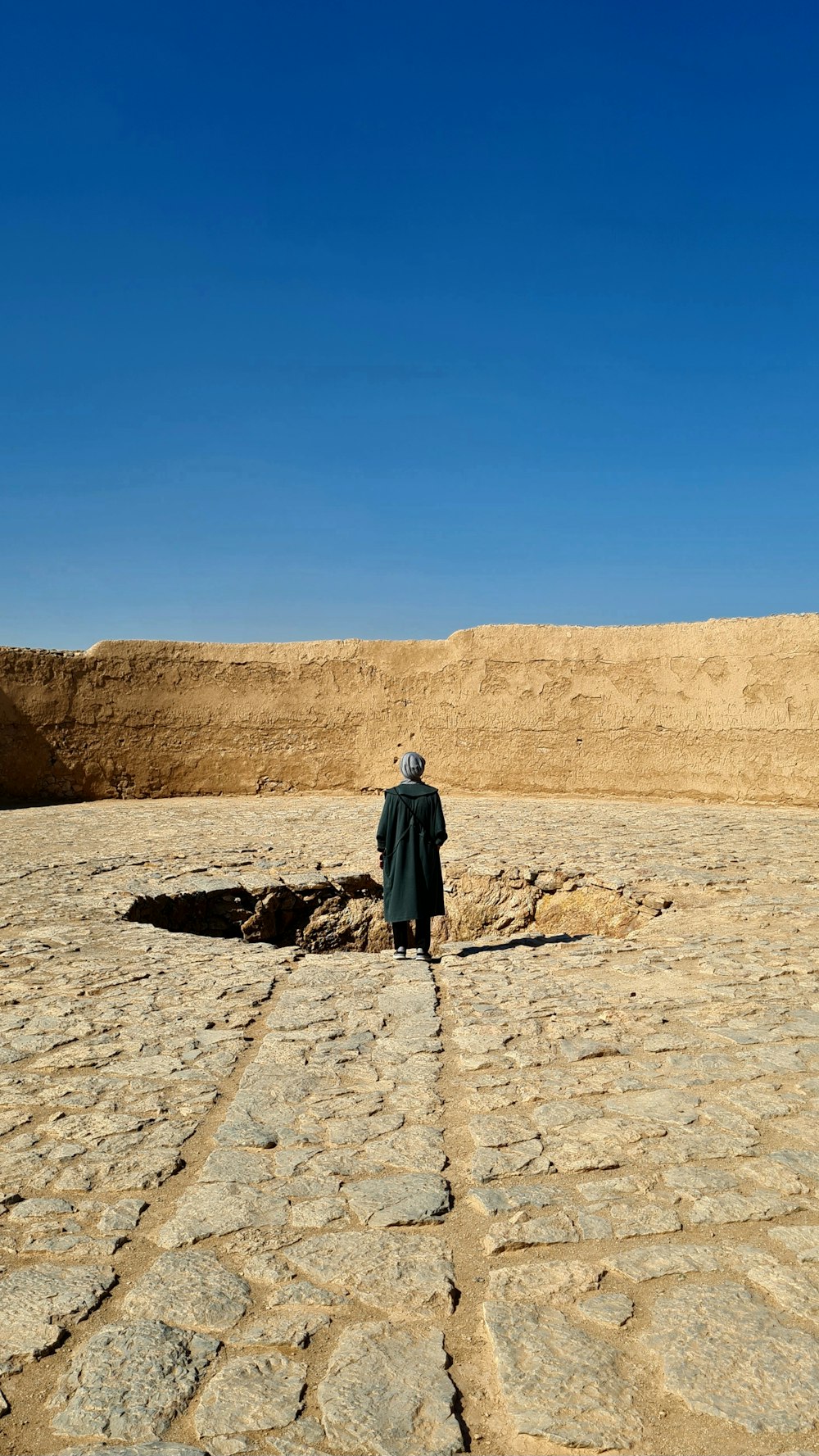 a man standing in the middle of a desert