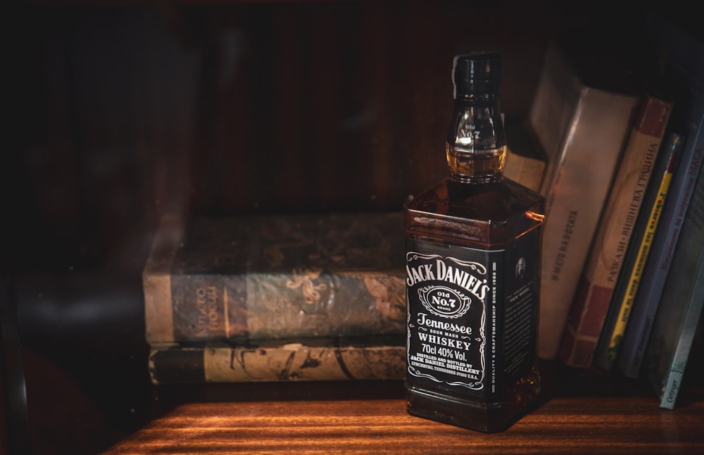 a bottle of whiskey sitting on top of a wooden table