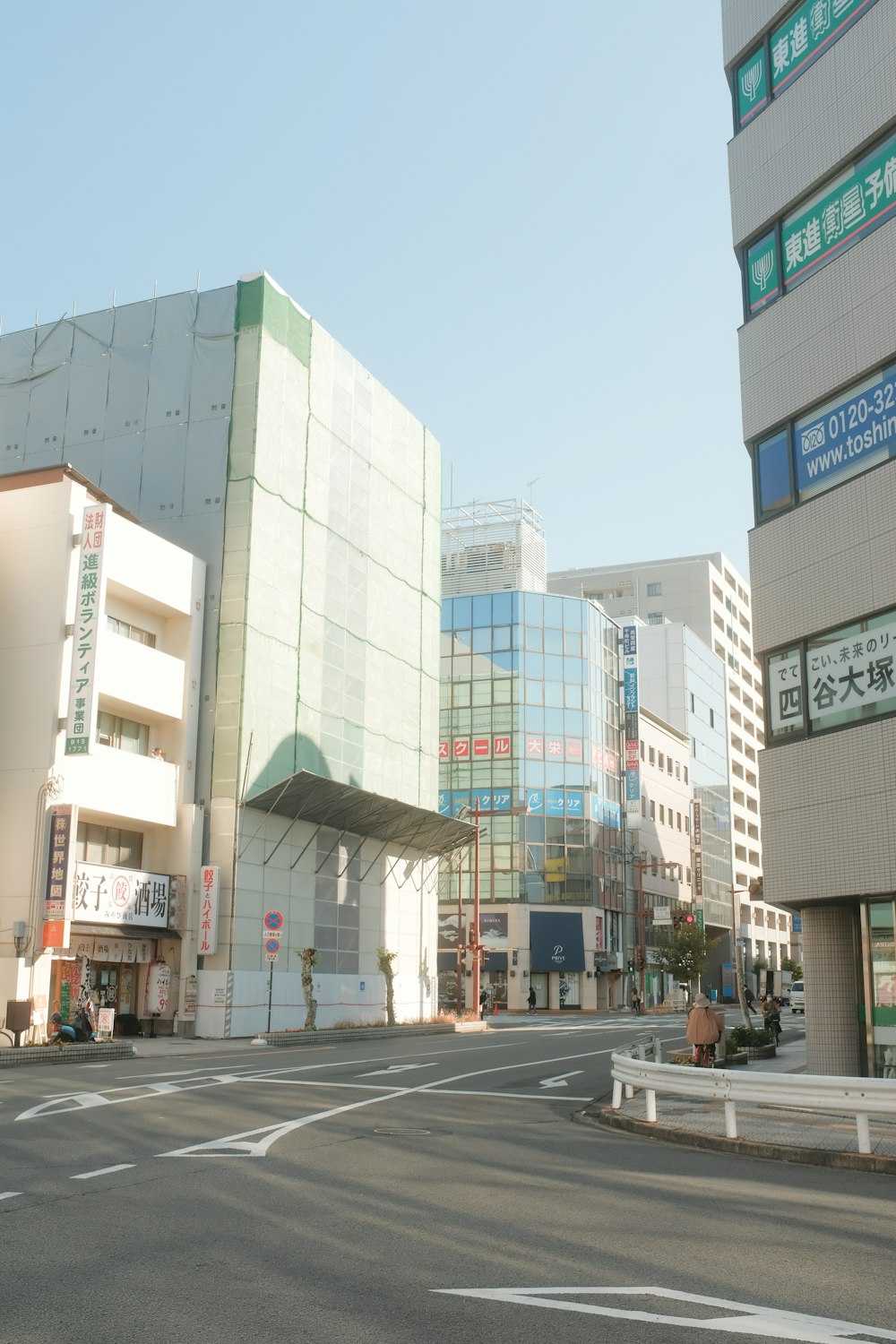 a city street with tall buildings in the background