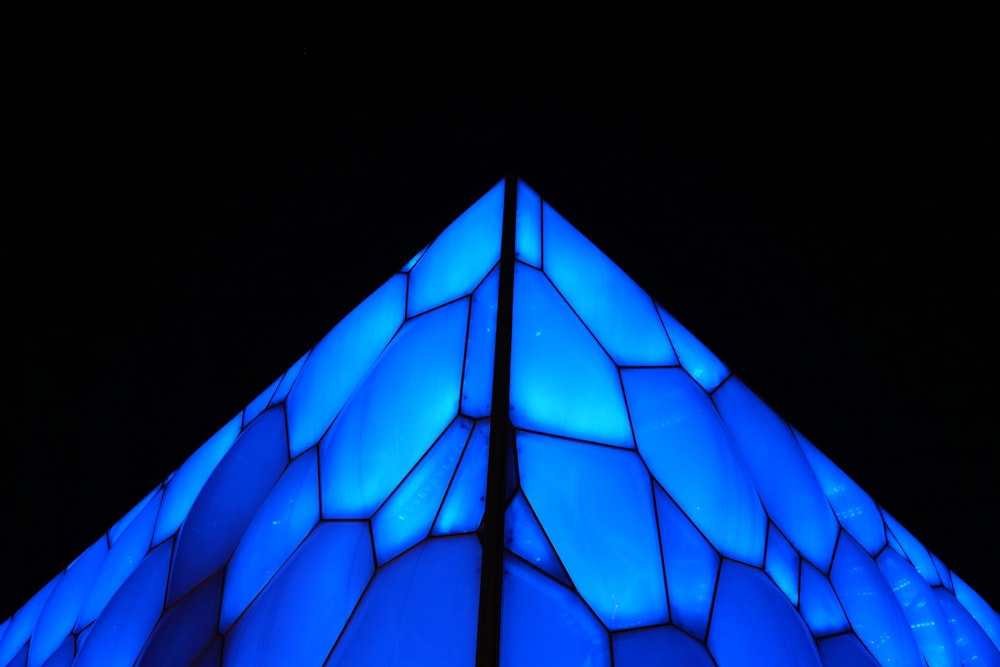 a tall building with a blue light on it's side