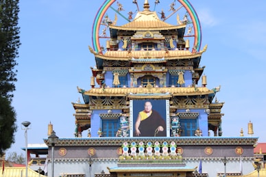 a large clock tower with a painting of a man on it