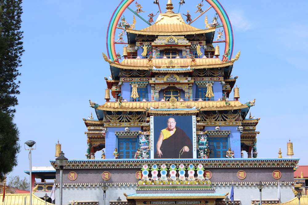 a large clock tower with a painting of a man on it