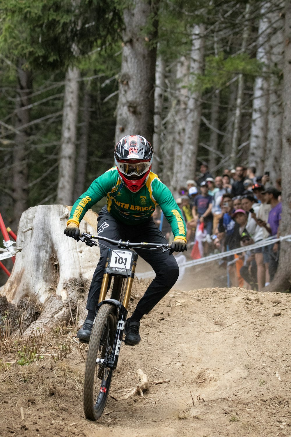 a man riding a bike down a dirt road