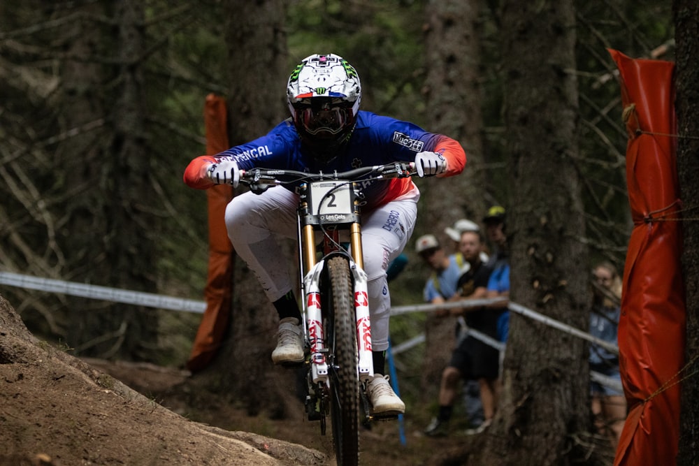 a man riding a bike down a dirt road