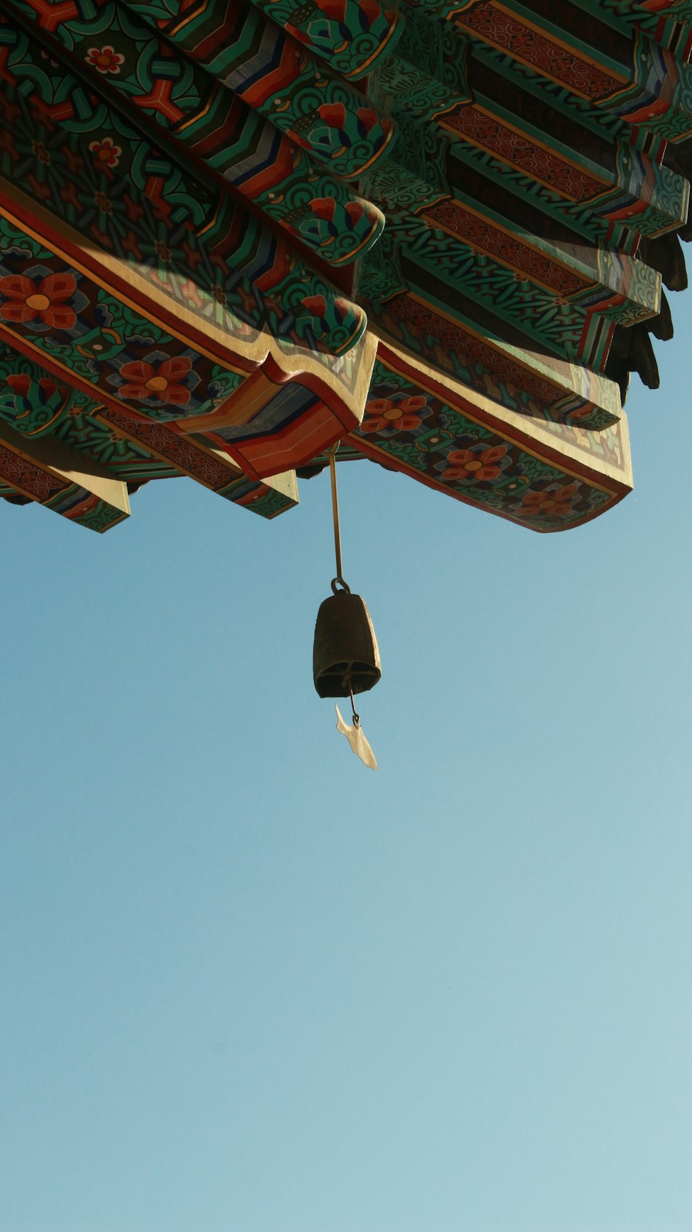 a bell hanging from the ceiling of a building