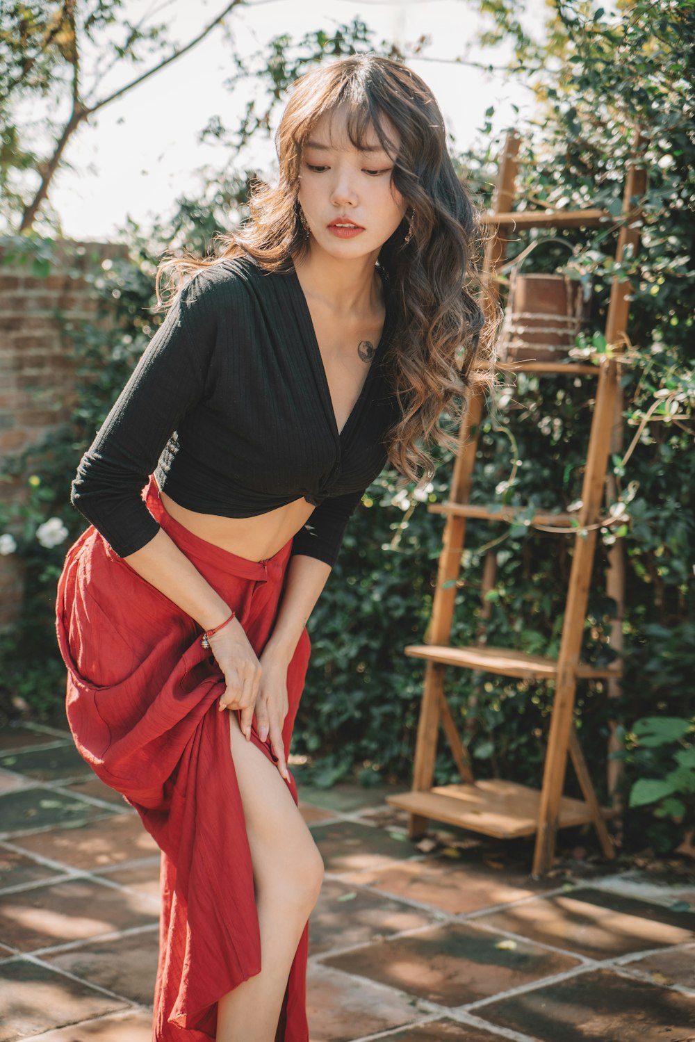 a woman in a red skirt posing for a picture