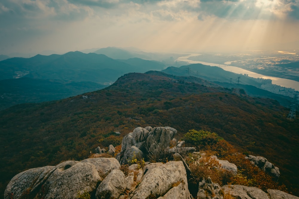 the sun shines through the clouds over the mountains