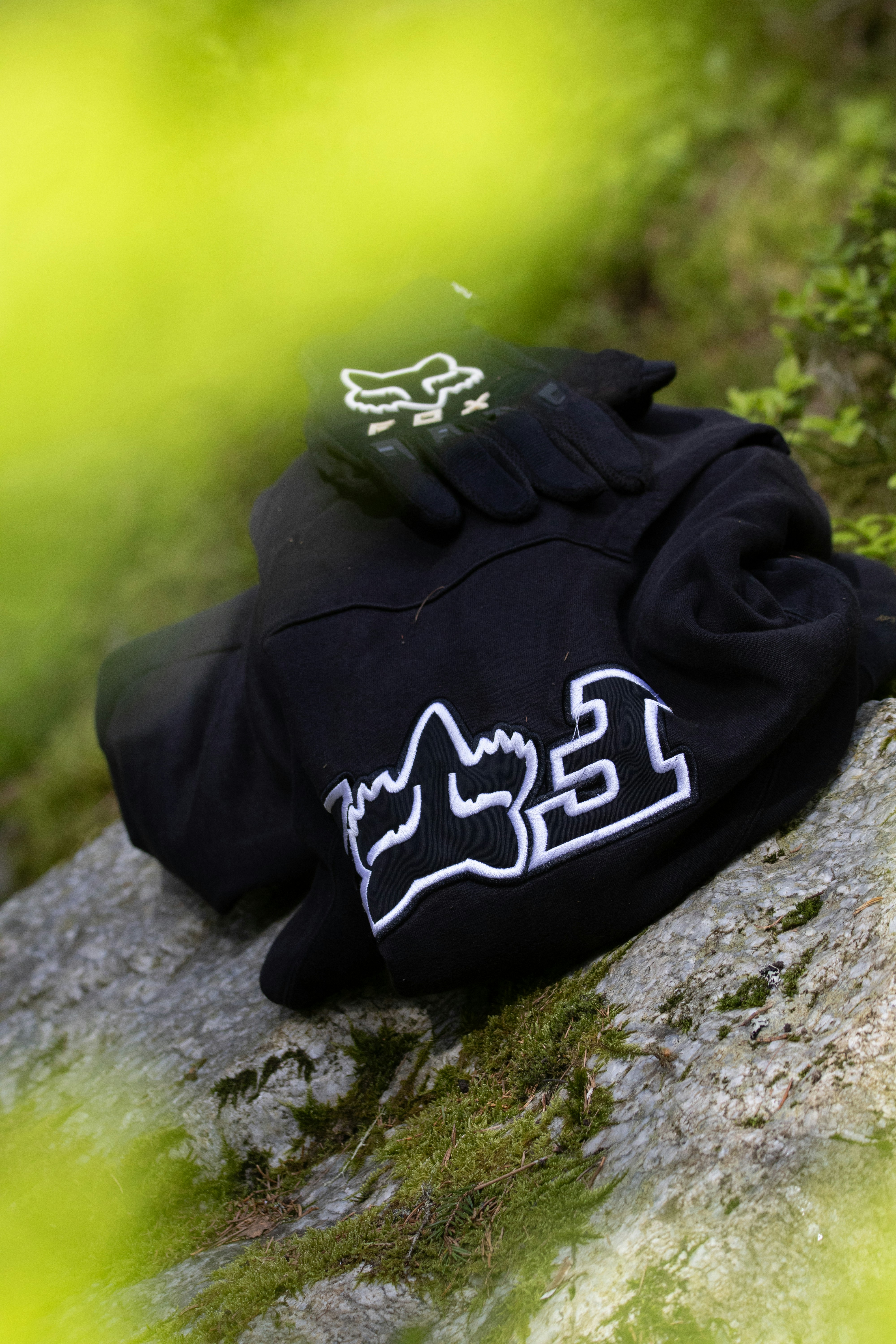 a pair of gloves sitting on top of a rock