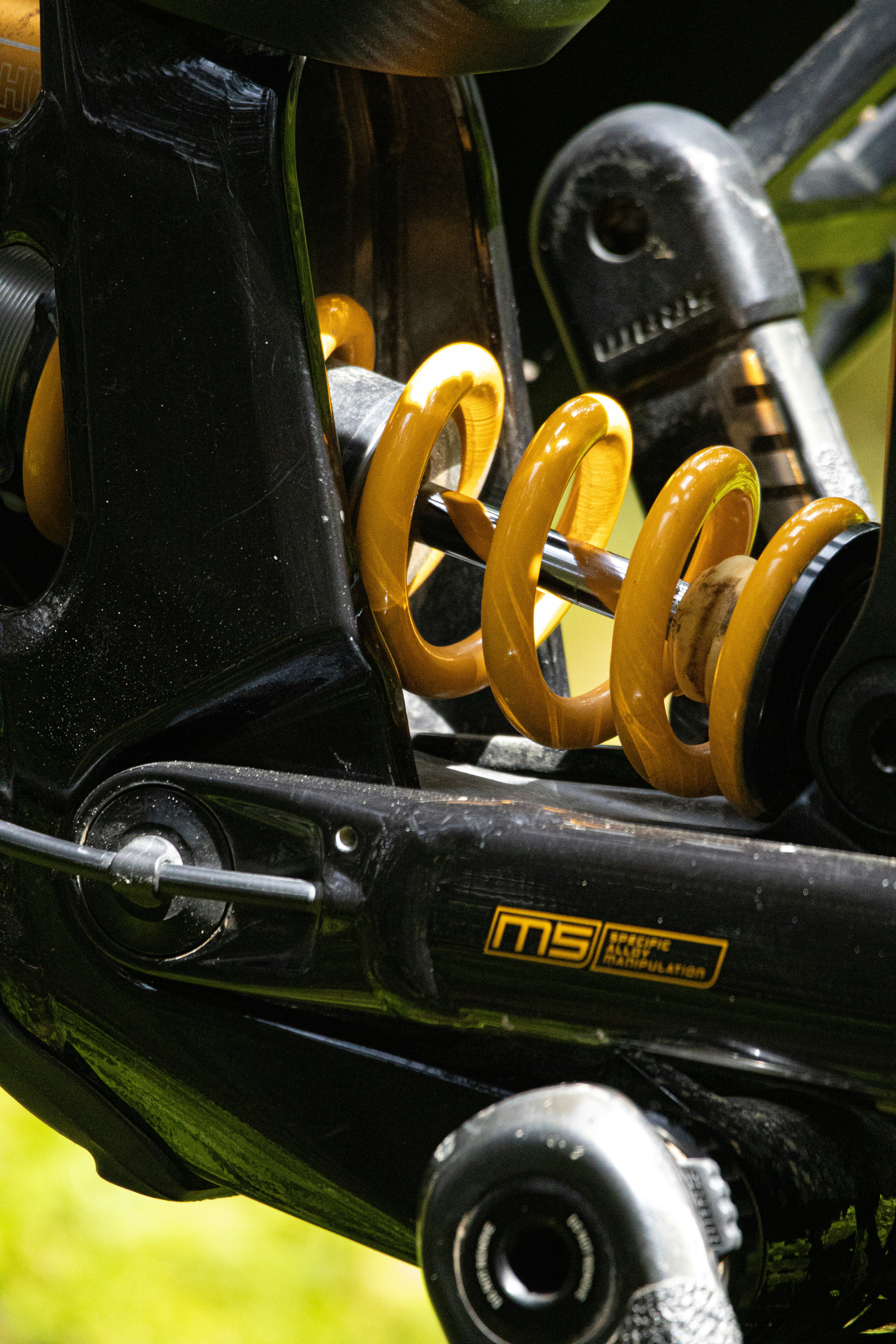 a close up of a bike with yellow springs