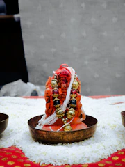 Handcrafted wooden puja thalis decorated with intricate patterns and filled with ritual items.