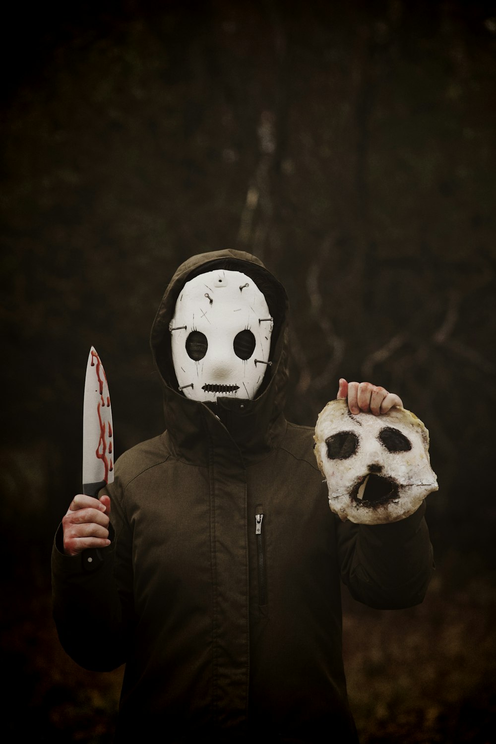 a person wearing a mask and holding a knife