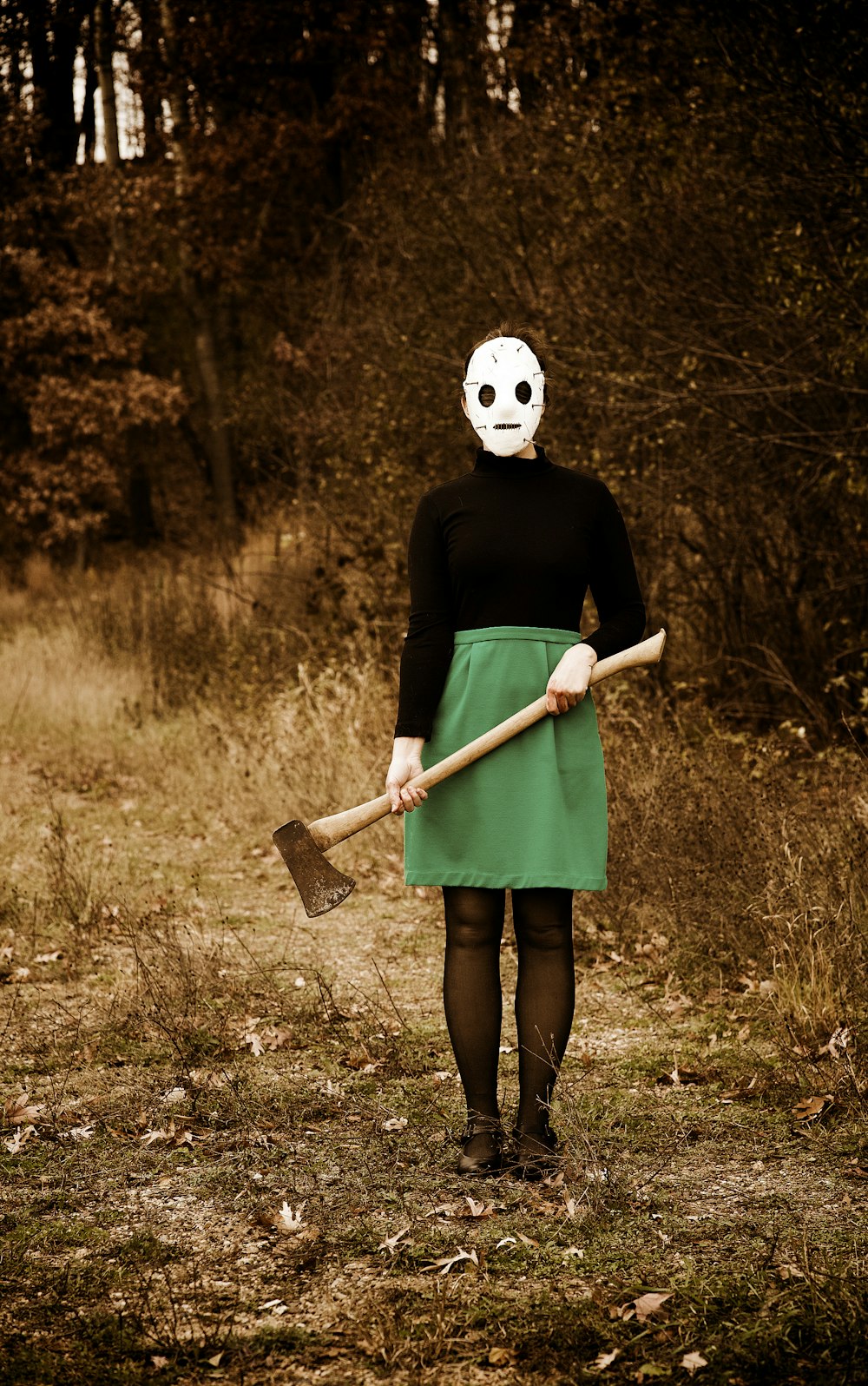 a woman wearing a mask and holding a shovel
