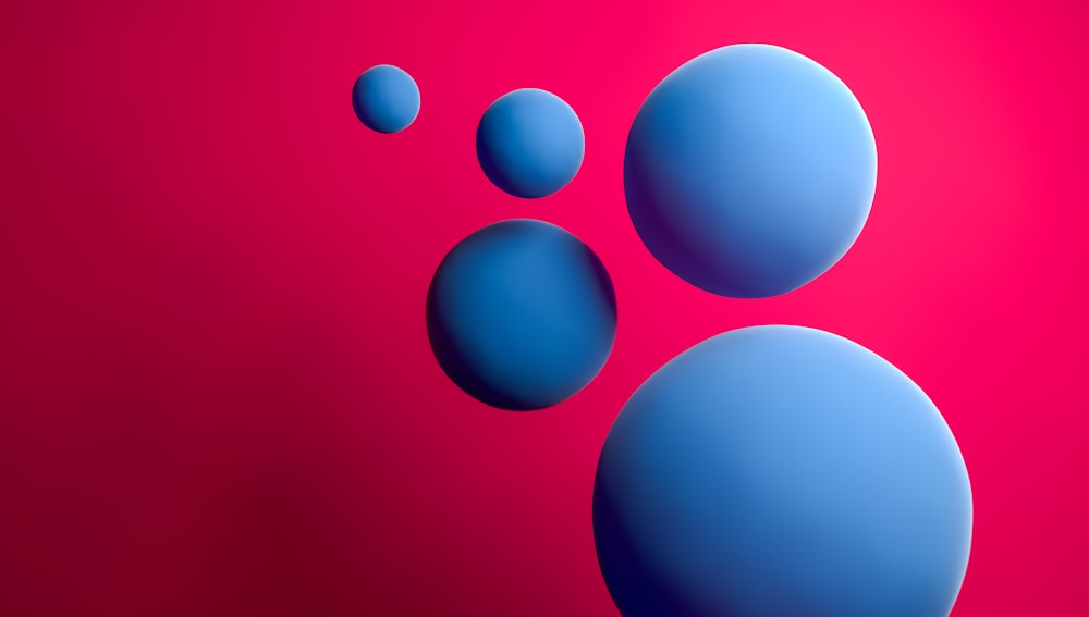 a red and blue background with three blue balls