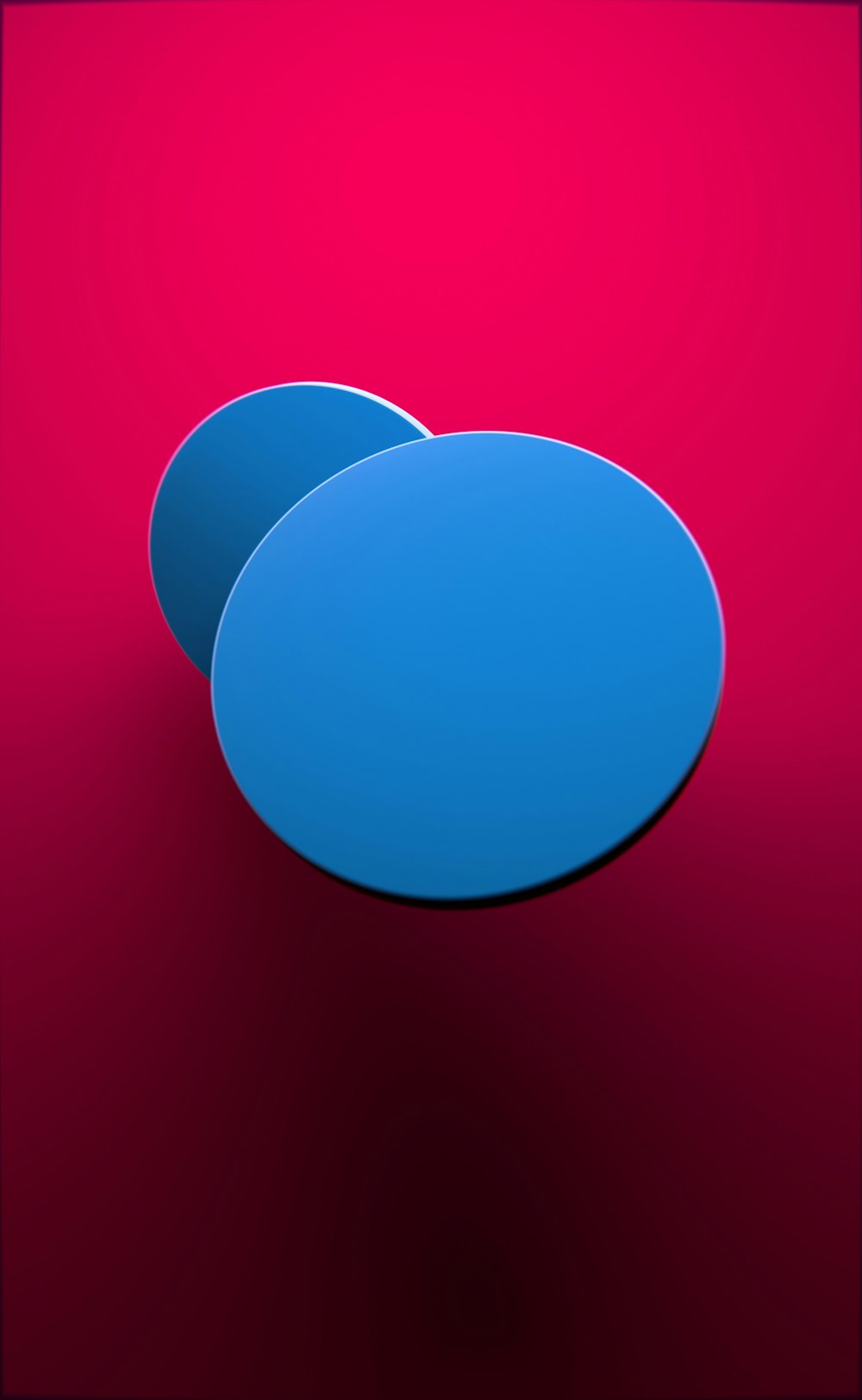 two blue circles sitting on top of a red surface