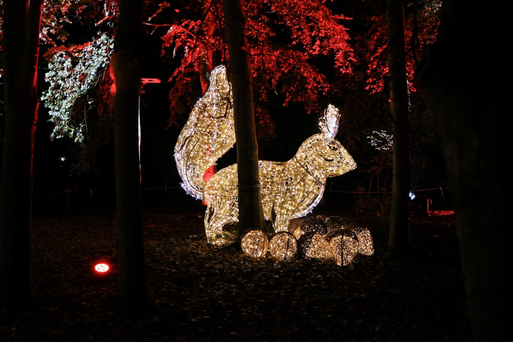 a lighted deer in the middle of a forest