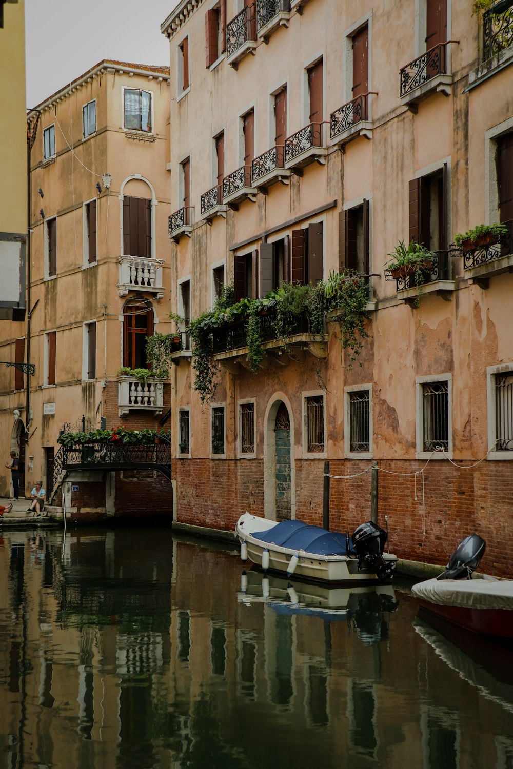 a boat is parked in a canal between two buildings