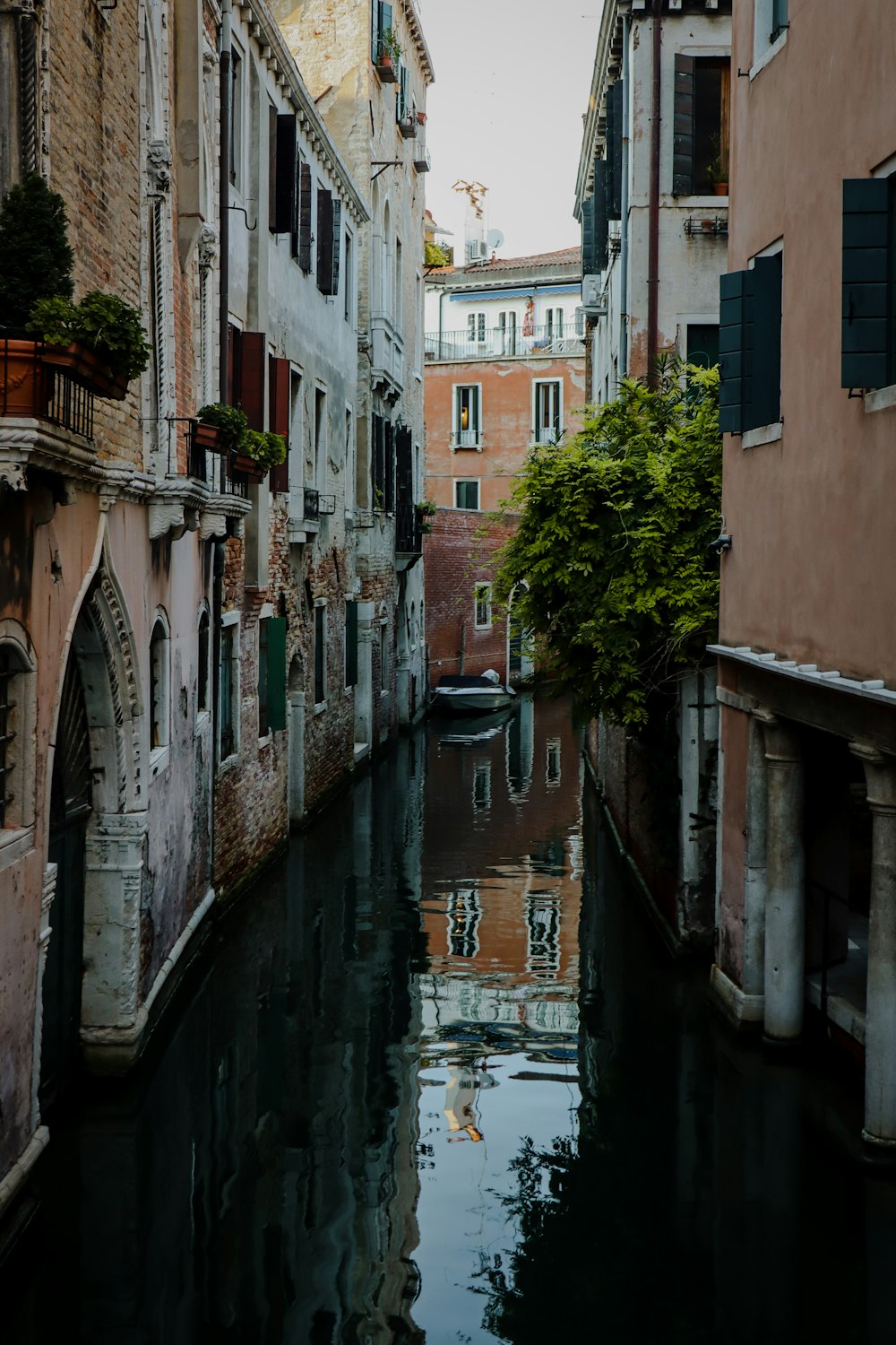 a narrow canal in a city with buildings on both sides