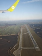 Aerial view of an airport runway blending into the natural landscape.