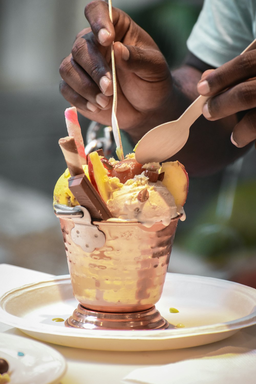 a person cutting into a dessert in a cup