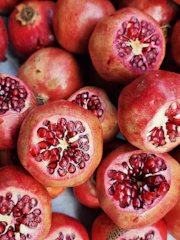 Close-up of vibrant, freshly harvested pomegranates on the farm.