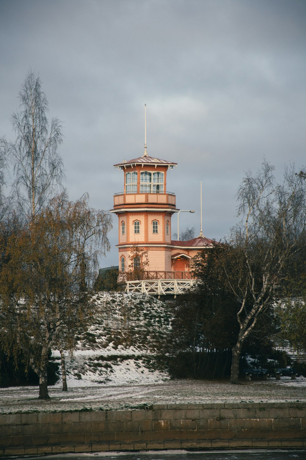 a building with a tower on top of a snowy hill