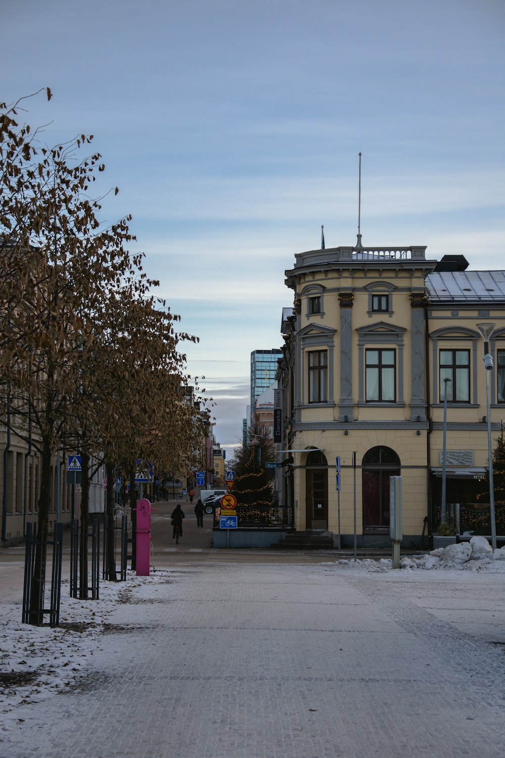 a building with a lot of windows and a lot of snow on the ground