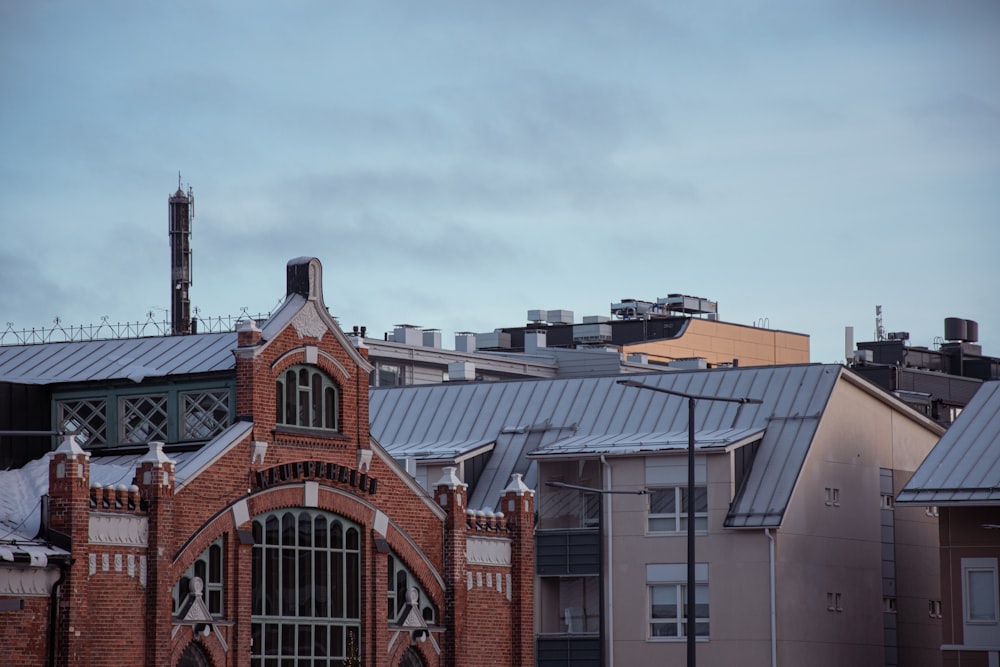 a brick building with a clock tower in the background