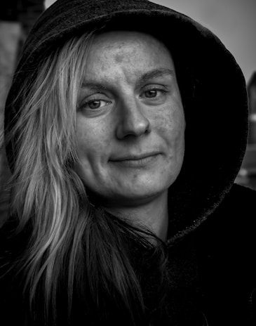 a black and white photo of a person wearing a hoodie