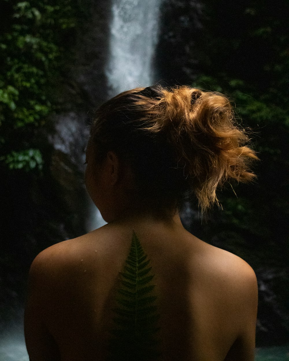 a woman with a fern tattoo on her back