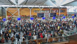 Travelers checking in at a modern airport, excited and ready for their adventure.