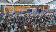 A bustling airport terminal with travelers checking in and boarding flights.