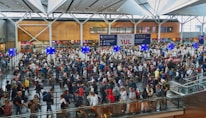 A bustling airport scene showing travelers checking in with smiles.