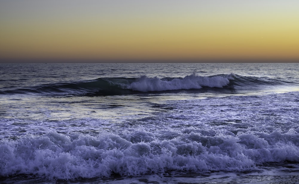 a large body of water with waves coming in to shore