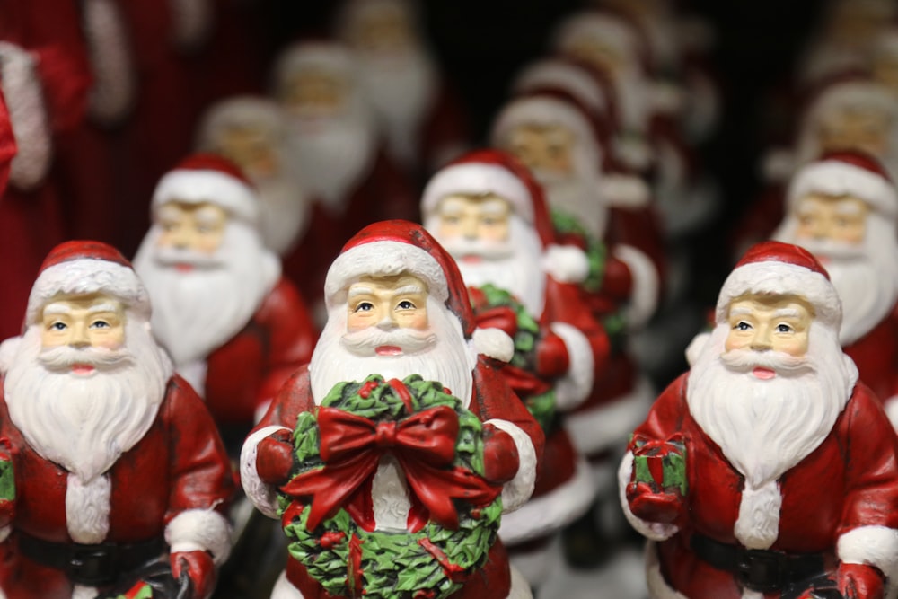 a group of santa claus figurines are lined up