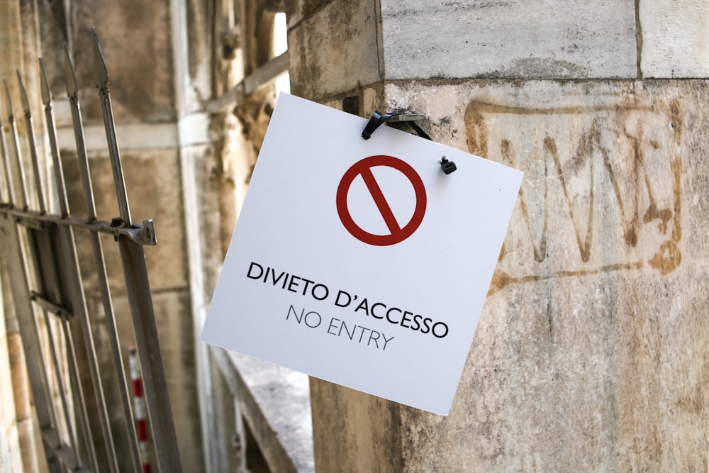 a no entry sign hanging on the side of a building