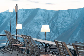 Outdoor seating area with elegant lighting and views of the surrounding Uttarakhand landscape.